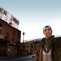 Niko stands in front of a humorous 'Cherkov' building.